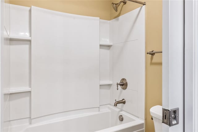 bathroom featuring shower / bathing tub combination and toilet