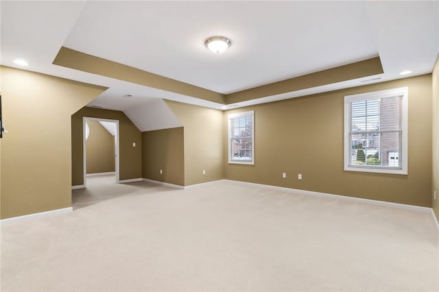 additional living space featuring light colored carpet