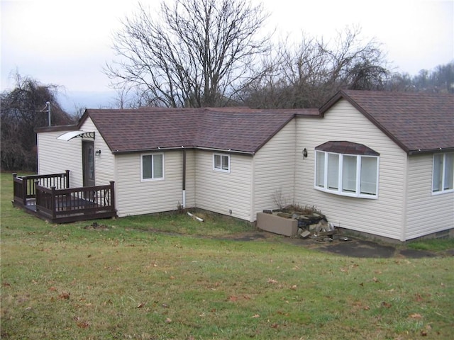 back of house with a lawn and a wooden deck