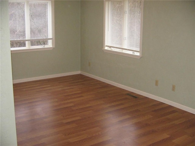 spare room with dark hardwood / wood-style flooring