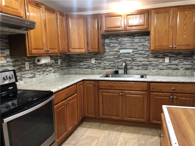 kitchen with decorative backsplash, sink, stainless steel electric range oven, and range hood