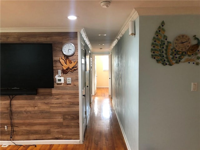 hallway with hardwood / wood-style floors and ornamental molding