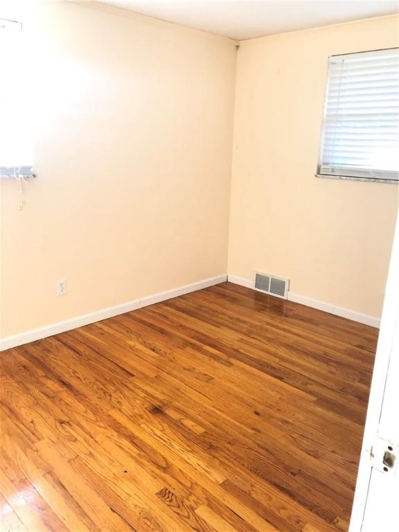 spare room with hardwood / wood-style flooring