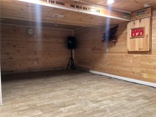 basement with wooden walls, wooden ceiling, and hardwood / wood-style flooring