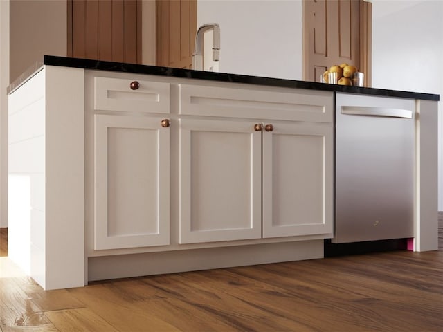 interior details featuring white cabinets, light hardwood / wood-style flooring, and dishwasher