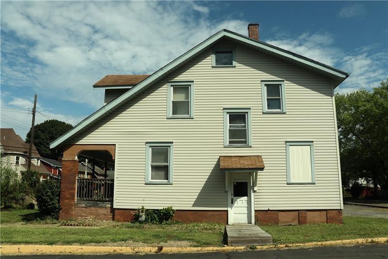 rear view of property featuring a lawn