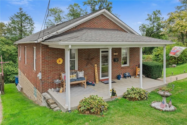 back of property with a yard and a patio