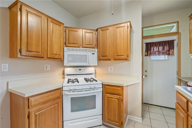 kitchen featuring white appliances and light tile patterned floors