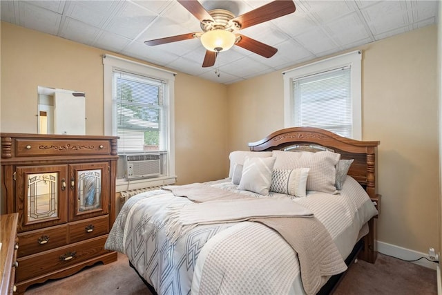 bedroom with cooling unit, ceiling fan, and carpet floors