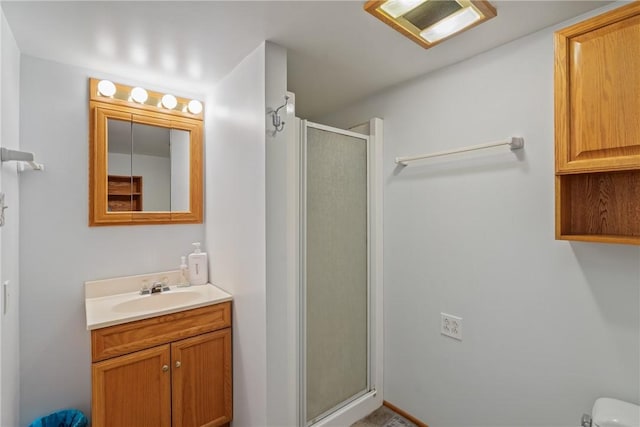 bathroom with vanity, toilet, and walk in shower