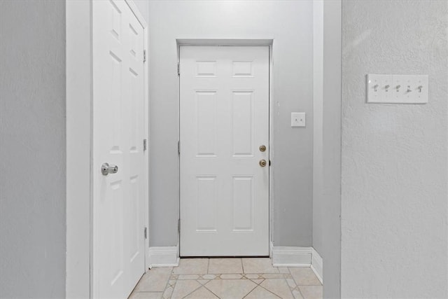 doorway to outside featuring light tile patterned floors