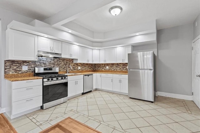 kitchen with white cabinets, sink, light tile patterned floors, light stone counters, and stainless steel appliances