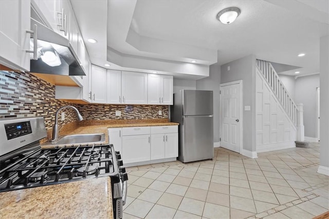 kitchen with white cabinetry, sink, tasteful backsplash, light tile patterned flooring, and appliances with stainless steel finishes