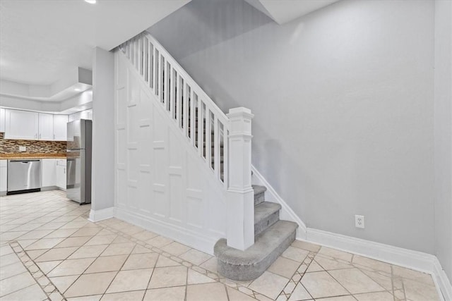 stairway with tile patterned flooring