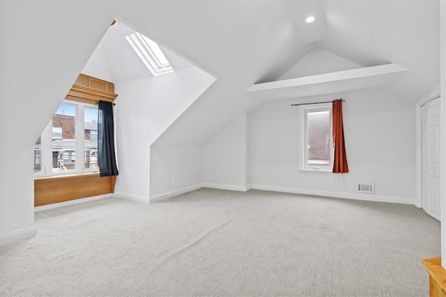 bonus room featuring carpet flooring, a healthy amount of sunlight, and lofted ceiling