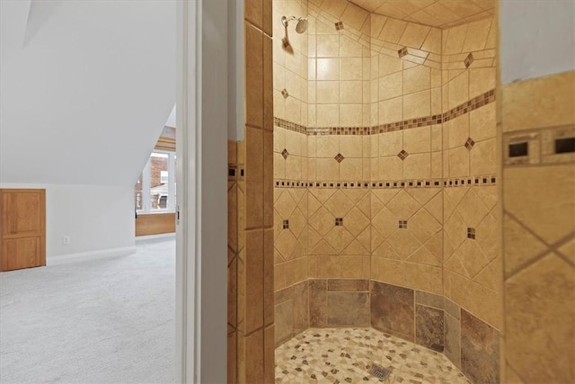 bathroom featuring a shower and lofted ceiling