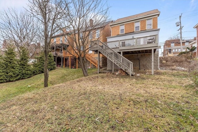 back of house featuring a deck and a lawn