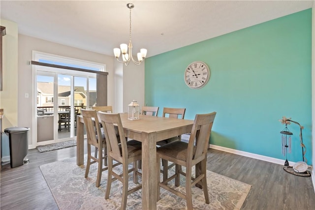 dining room featuring an inviting chandelier and dark wood-type flooring