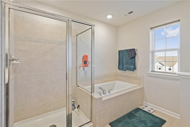 bathroom featuring tile patterned flooring and separate shower and tub