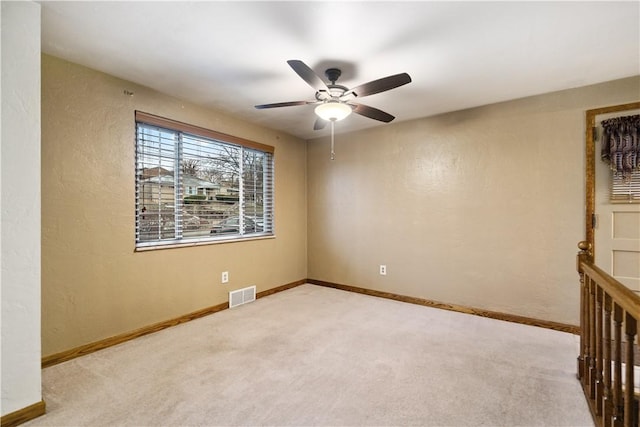 carpeted empty room with ceiling fan