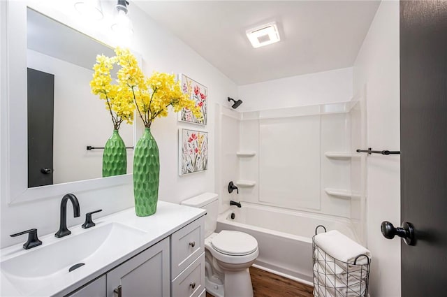 full bathroom with vanity, hardwood / wood-style flooring, toilet, and shower / washtub combination