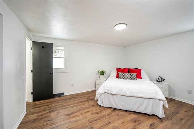 bedroom featuring dark wood-type flooring