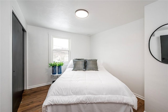 bedroom featuring dark hardwood / wood-style flooring and a closet