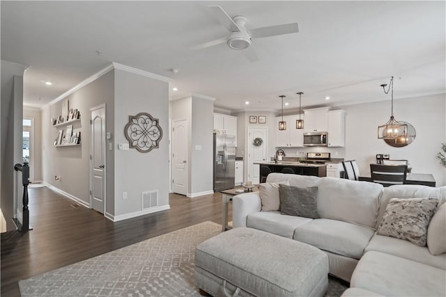 living room with ceiling fan, dark hardwood / wood-style floors, and crown molding