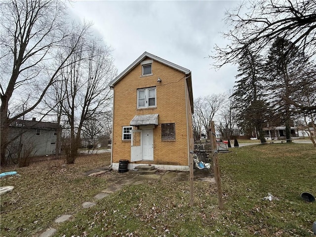 rear view of property with a yard