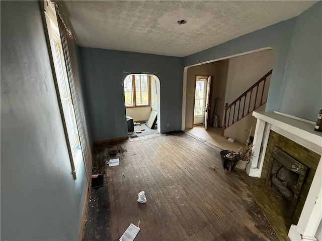 living room with a textured ceiling and hardwood / wood-style flooring