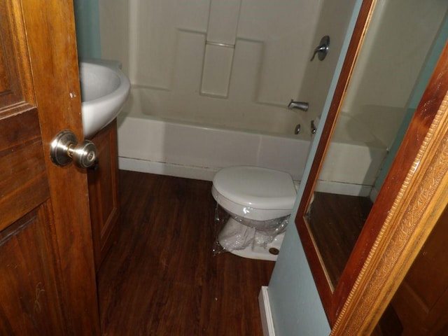 full bathroom with vanity, hardwood / wood-style flooring, toilet, and  shower combination