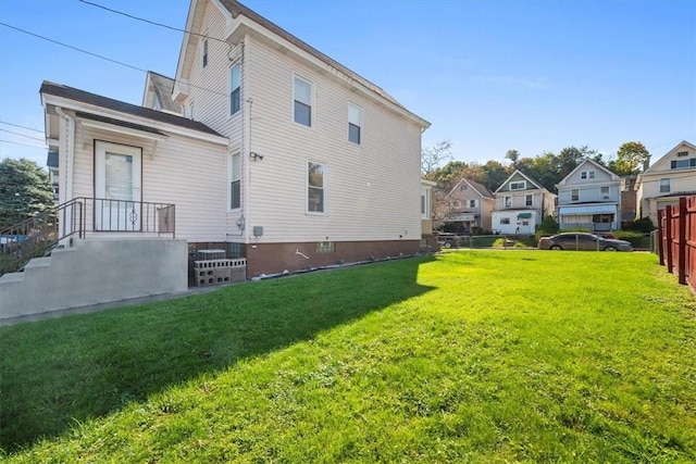 rear view of house with a lawn