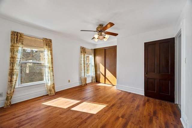 unfurnished room with hardwood / wood-style flooring, ceiling fan, and a wealth of natural light