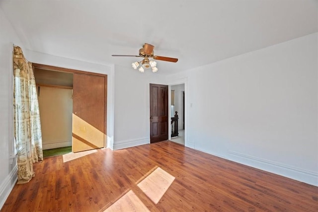 unfurnished room with hardwood / wood-style flooring and ceiling fan