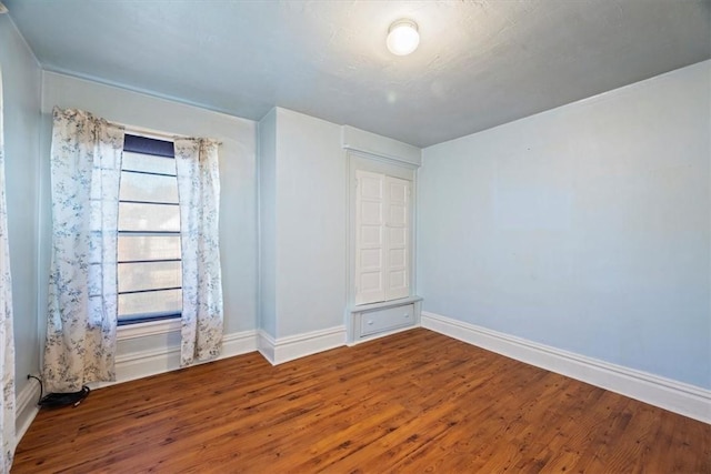 spare room with hardwood / wood-style floors