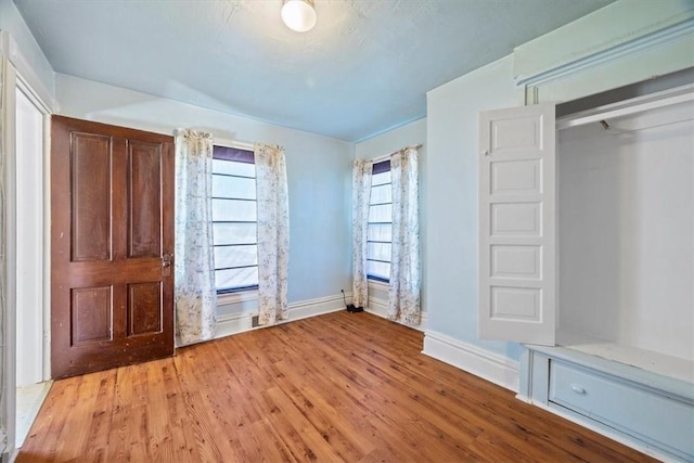 unfurnished bedroom with light hardwood / wood-style floors and a closet