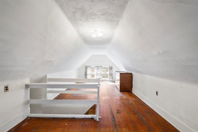 additional living space with dark hardwood / wood-style flooring and lofted ceiling