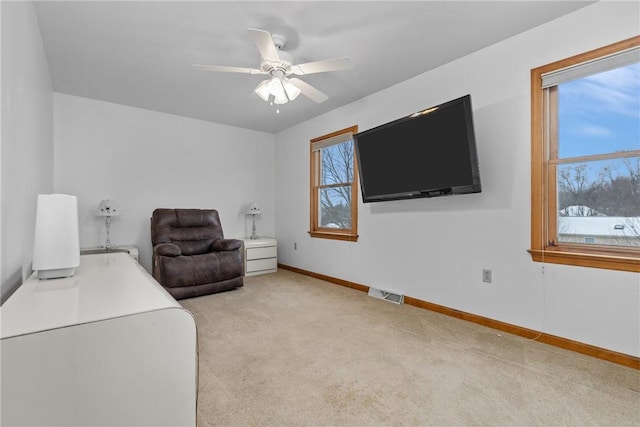 sitting room featuring ceiling fan and light colored carpet