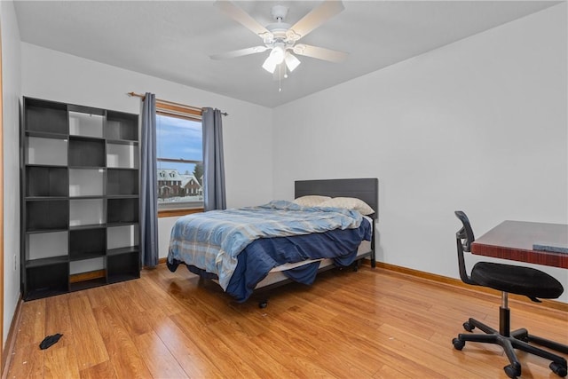 bedroom with ceiling fan and wood-type flooring