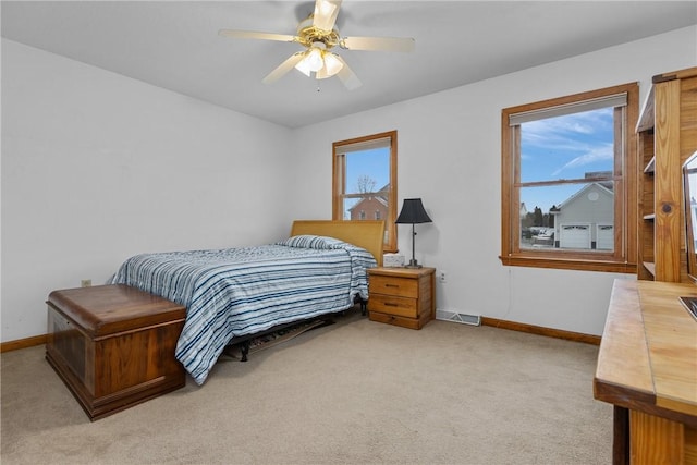 bedroom with light carpet and ceiling fan