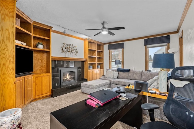 living room featuring ceiling fan, crown molding, light carpet, and built in shelves