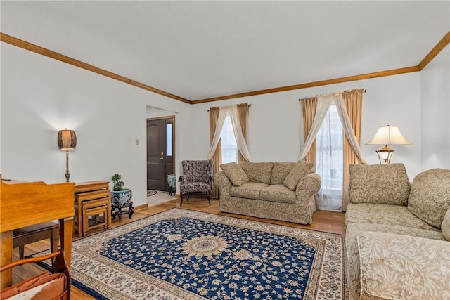 living room with hardwood / wood-style flooring and crown molding