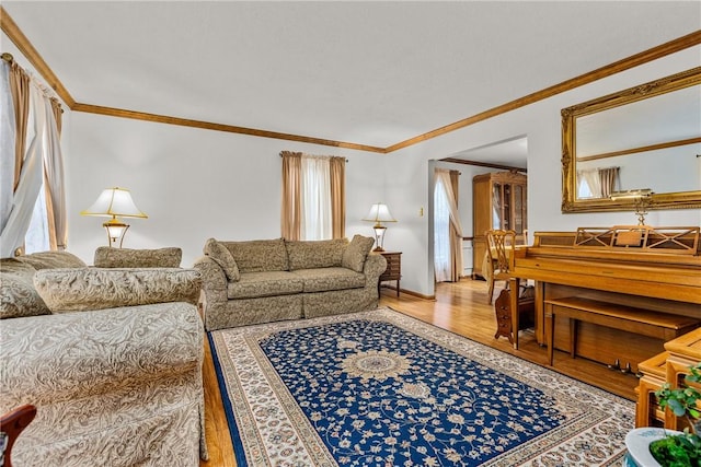 living room featuring wood-type flooring, ornamental molding, and a healthy amount of sunlight