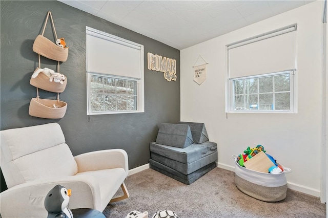 living area featuring carpet flooring and a healthy amount of sunlight