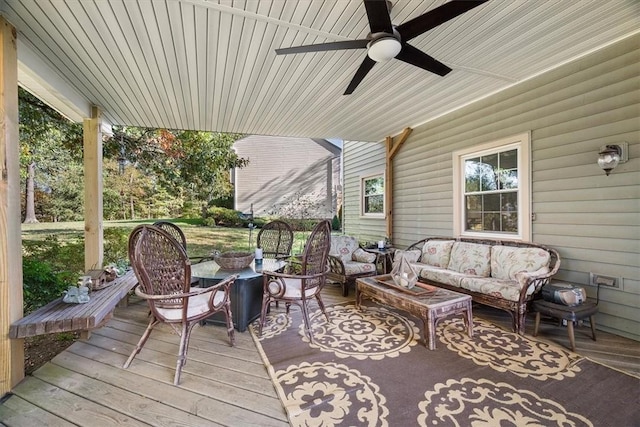 deck with an outdoor living space and ceiling fan