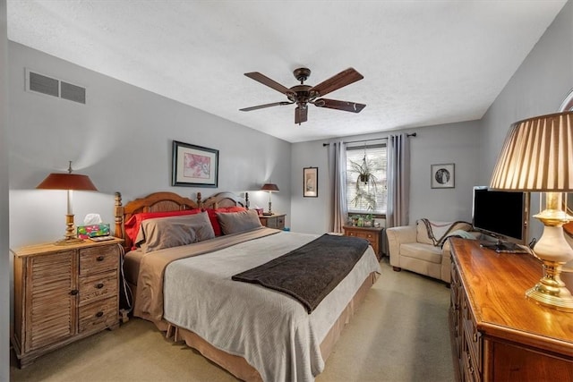 bedroom featuring carpet flooring, a textured ceiling, and ceiling fan