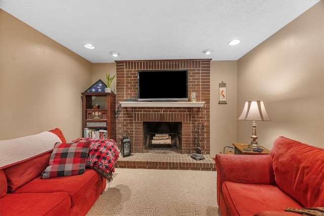 living room featuring carpet floors, a textured ceiling, and a brick fireplace