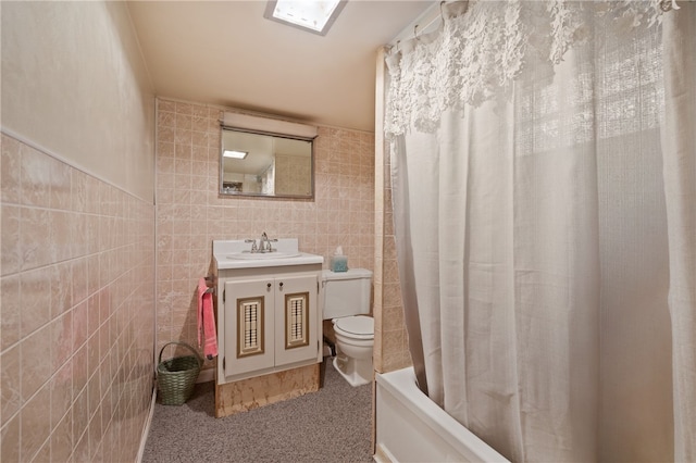 full bathroom featuring shower / bath combination with curtain, toilet, tile walls, and vanity