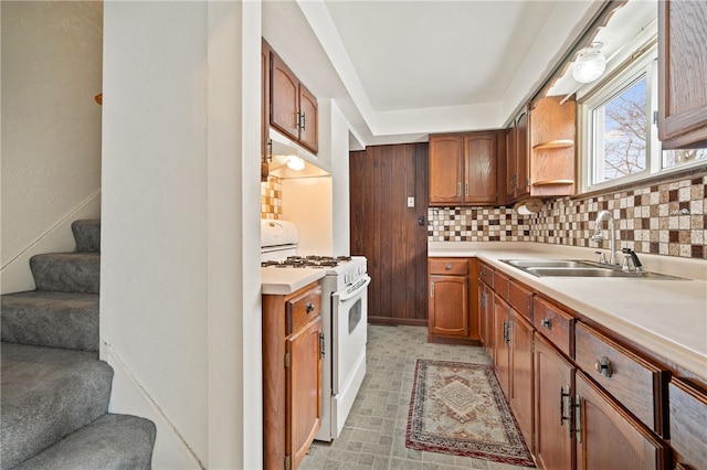 kitchen with backsplash, sink, and gas range gas stove