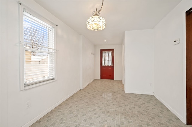 foyer featuring an inviting chandelier